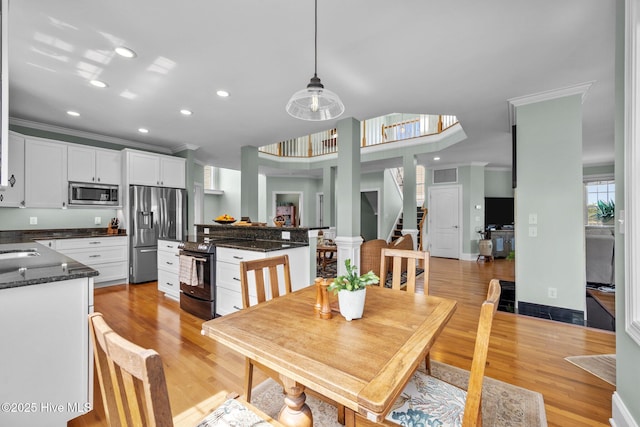 208 Sea Manor Dr, Surf City, NC 28445 - dining space featuring recessed lighting, crown molding, and light wood-style flooring