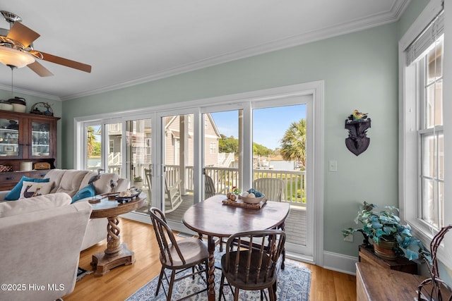 208 Sea Manor Dr, Surf City, NC 28445 - dining room featuring crown molding, light wood-style floors, baseboards, and a ceiling fan