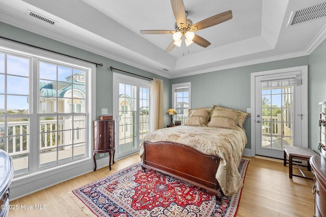 208 Sea Manor Dr, Surf City, NC 28445 - bedroom featuring access to exterior, multiple windows, and a tray ceiling