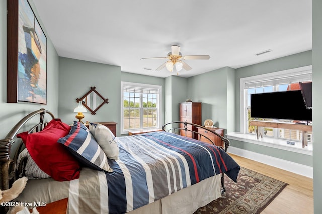 208 Sea Manor Dr, Surf City, NC 28445 - bedroom featuring baseboards, wood finished floors, and a ceiling fan