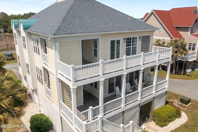 208 Sea Manor Dr, Surf City, NC 28445 - rear view of house featuring roof with shingles