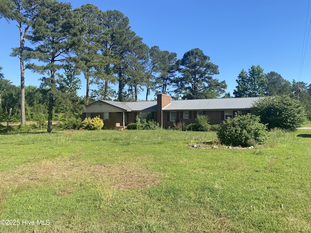 691 Wade Daughtry Rd, Faison, NC 28341 - view of front of property featuring a chimney, metal roof, and a front lawn