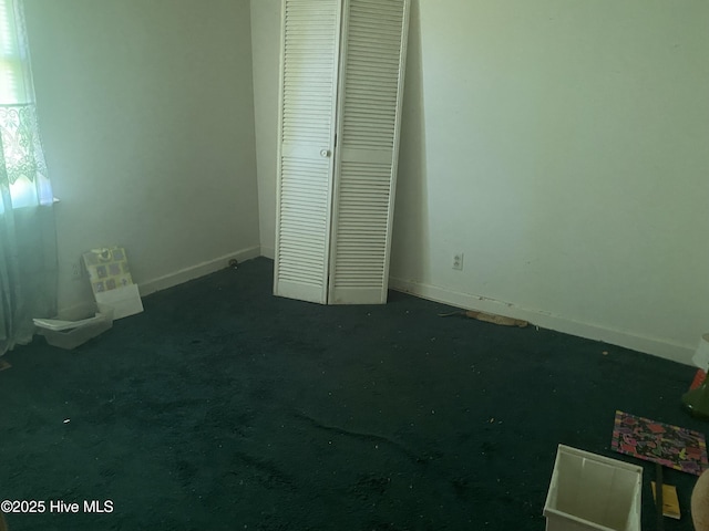 691 Wade Daughtry Rd, Faison, NC 28341 - unfurnished bedroom with a closet, baseboards, and carpet floors