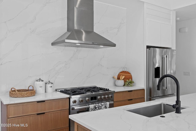 1100 S Sixth St, Carolina Beach, NC 28428 - kitchen with stainless steel appliances, wall chimney range hood, decorative backsplash, light stone countertops, and a sink