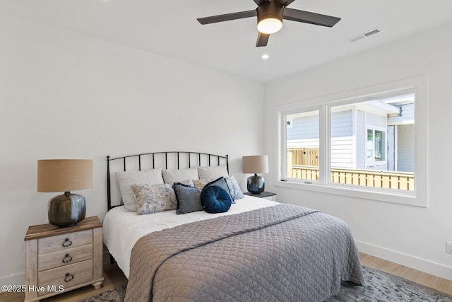 1100 S Sixth St, Carolina Beach, NC 28428 - bedroom with wood finished floors, baseboards, a ceiling fan, and recessed lighting