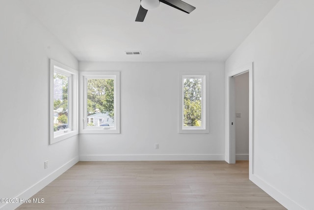 1100 S Sixth St, Carolina Beach, NC 28428 - unfurnished room with plenty of natural light, ceiling fan, and light wood-style floors