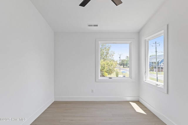 1100 S Sixth St, Carolina Beach, NC 28428 - spare room with light wood finished floors, a ceiling fan, and baseboards