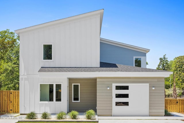 1100 S Sixth St, Carolina Beach, NC 28428 - view of front facade with roof with shingles, board and batten siding, and an attached garage