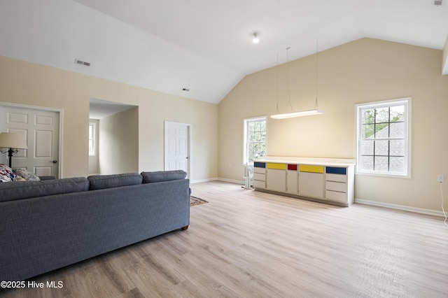 482 Riverwood Dr SE, Bolivia, NC 28422 - living room with vaulted ceiling, light wood-style floors, and baseboards