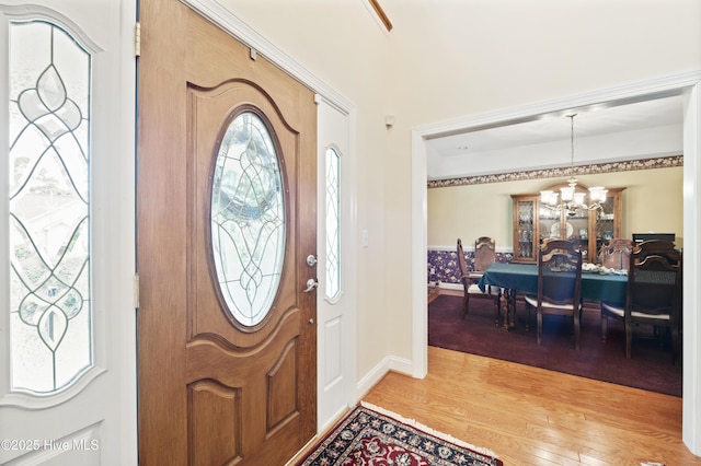 482 Riverwood Dr SE, Bolivia, NC 28422 - foyer featuring a chandelier, wood finished floors, and baseboards