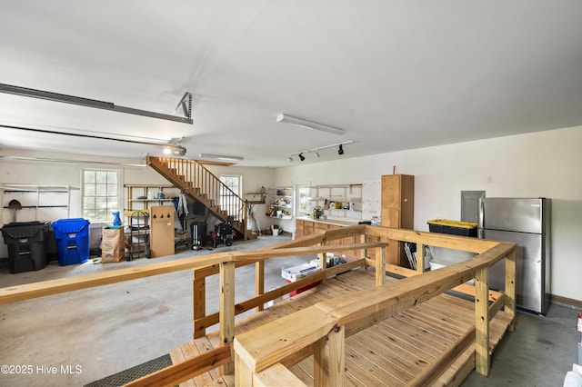 482 Riverwood Dr SE, Bolivia, NC 28422 - garage with freestanding refrigerator and a garage door opener