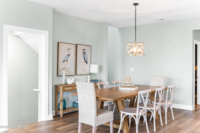 822 S Topsail Dr Unit B, Surf City, NC 28445 - dining area featuring a chandelier, wood finished floors, and baseboards