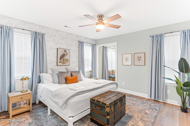 822 S Topsail Dr Unit B, Surf City, NC 28445 - bedroom with baseboards, wood finished floors, wallpapered walls, and a ceiling fan