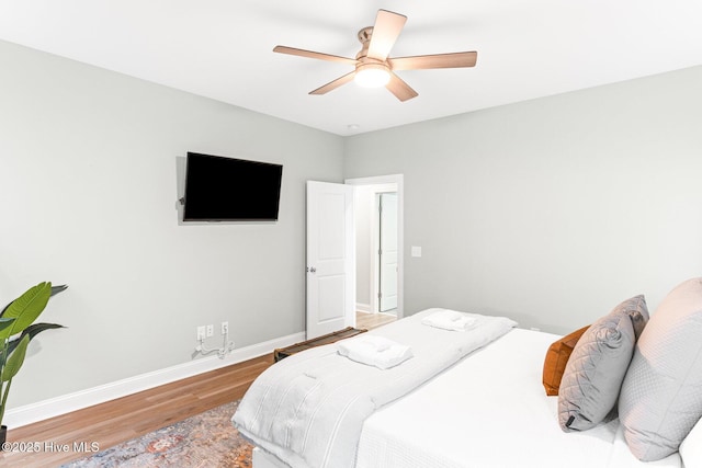 822 S Topsail Dr Unit B, Surf City, NC 28445 - bedroom featuring wood finished floors, baseboards, and a ceiling fan