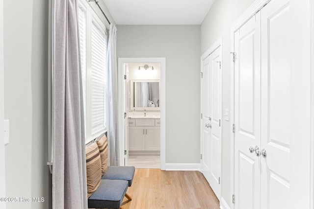 822 S Topsail Dr Unit B, Surf City, NC 28445 - hallway with light wood-type flooring, a sink, and baseboards