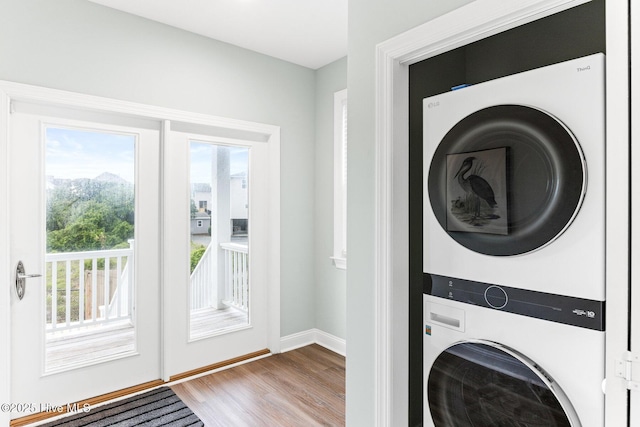 822 S Topsail Dr Unit B, Surf City, NC 28445 - laundry area featuring stacked washer / dryer, wood finished floors, and baseboards
