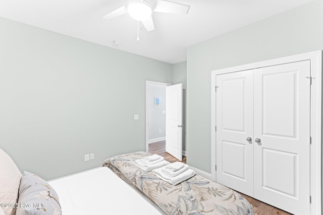 822 S Topsail Dr Unit B, Surf City, NC 28445 - bedroom with light wood finished floors, a closet, and ceiling fan
