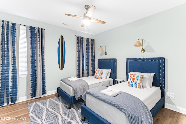 822 S Topsail Dr Unit B, Surf City, NC 28445 - bedroom with wood finished floors, baseboards, and ceiling fan