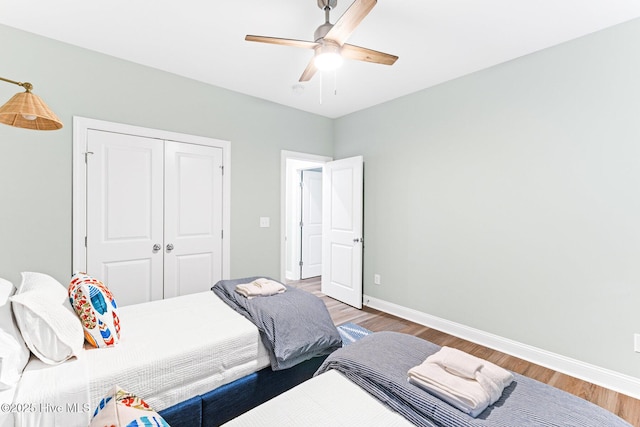 822 S Topsail Dr Unit B, Surf City, NC 28445 - bedroom featuring wood finished floors, baseboards, a closet, and ceiling fan