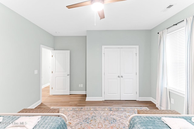 822 S Topsail Dr Unit B, Surf City, NC 28445 - unfurnished bedroom featuring wood finished floors, a closet, baseboards, and multiple windows