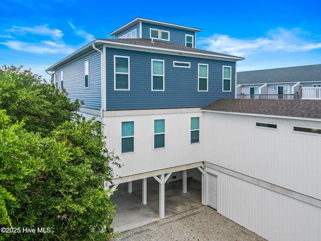 822 S Topsail Dr Unit B, Surf City, NC 28445 - back of property featuring a carport and a shingled roof