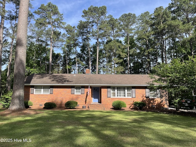 single story home featuring entry steps, brick siding, and a front yard