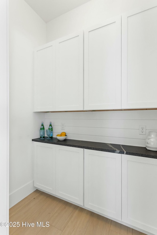 609 Augusta Ave, Carolina Beach, NC 28428 - kitchen featuring light wood-style flooring, white cabinets, and baseboards