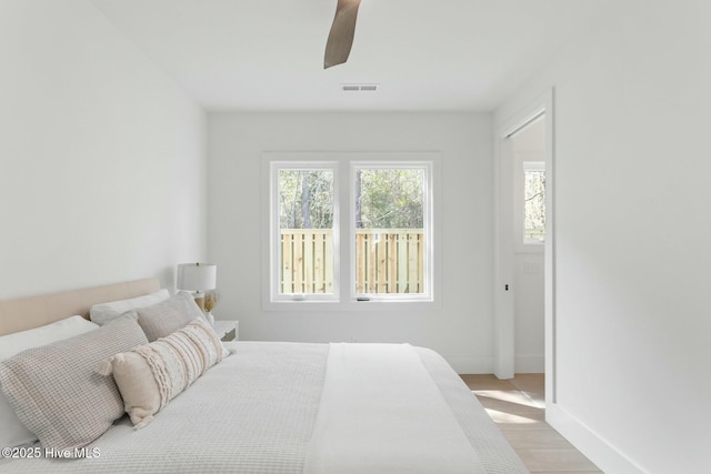 609 Augusta Ave, Carolina Beach, NC 28428 - bedroom with light wood-style floors, a ceiling fan, and baseboards