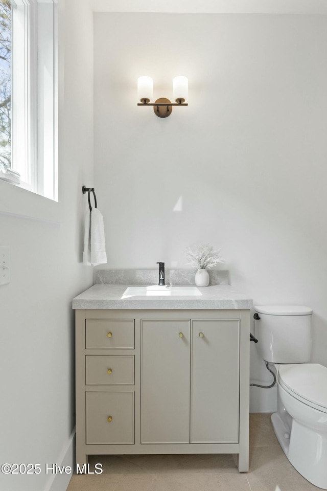 609 Augusta Ave, Carolina Beach, NC 28428 - bathroom with toilet, vanity, and tile patterned floors