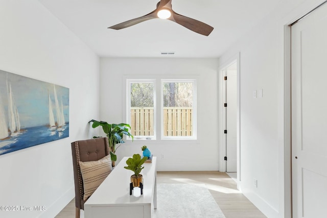 609 Augusta Ave, Carolina Beach, NC 28428 - home office with baseboards, light wood-type flooring, and a ceiling fan