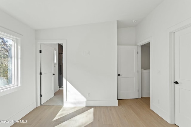 609 Augusta Ave, Carolina Beach, NC 28428 - unfurnished bedroom featuring light wood-style flooring and baseboards