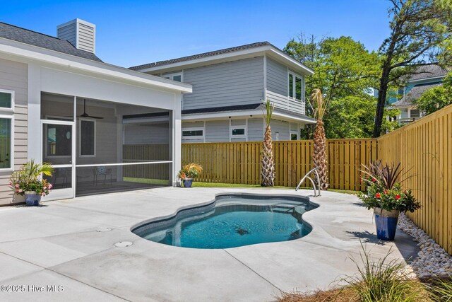 609 Augusta Ave, Carolina Beach, NC 28428 - view of swimming pool featuring a sunroom, a fenced backyard, and a patio area