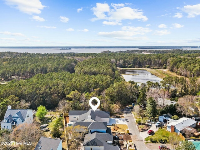 609 Augusta Ave, Carolina Beach, NC 28428 - aerial perspective of suburban area featuring a heavily wooded area and a large body of water