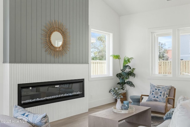 609 Augusta Ave, Carolina Beach, NC 28428 - living area featuring a glass covered fireplace and wood finished floors