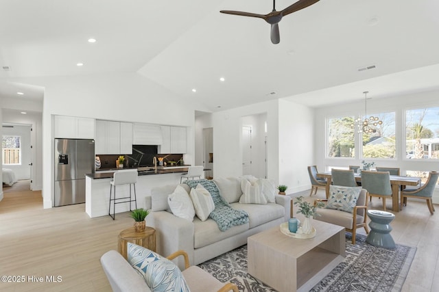 609 Augusta Ave, Carolina Beach, NC 28428 - living area with plenty of natural light, light wood-type flooring, a ceiling fan, recessed lighting, and high vaulted ceiling