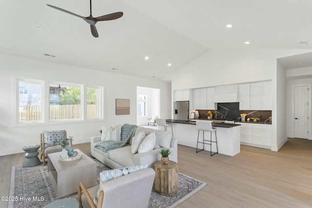609 Augusta Ave, Carolina Beach, NC 28428 - living area with light wood finished floors, high vaulted ceiling, ceiling fan, recessed lighting, and baseboards