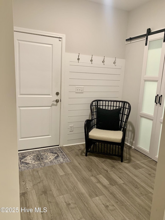 8941 Cobble Ridge Dr, Wilmington, NC 28411 - mudroom featuring wood finished floors and a barn door