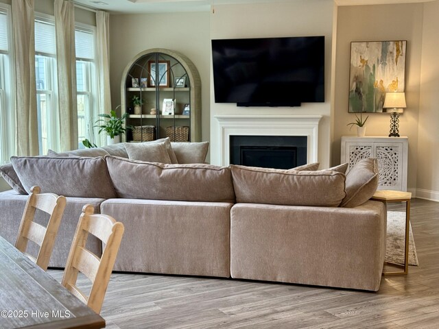 8941 Cobble Ridge Dr, Wilmington, NC 28411 - living area featuring wood finished floors, a fireplace, and baseboards