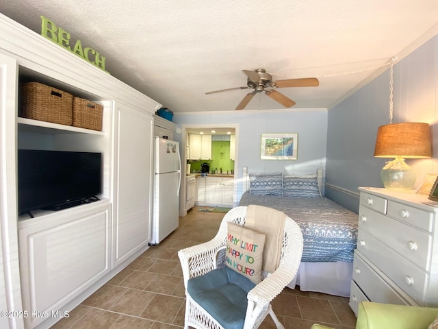 1918 W Fort Macon Rd Unit 160, Atlantic Beach, NC 28512 - bedroom featuring freestanding refrigerator, light tile patterned floors, and a ceiling fan
