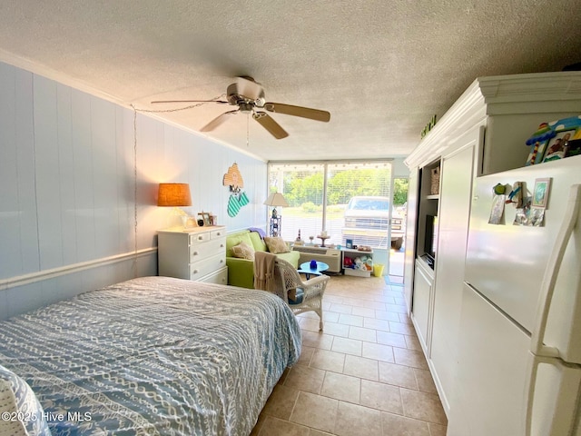 1918 W Fort Macon Rd Unit 160, Atlantic Beach, NC 28512 - bedroom with freestanding refrigerator, tile patterned flooring, a ceiling fan, and a textured ceiling