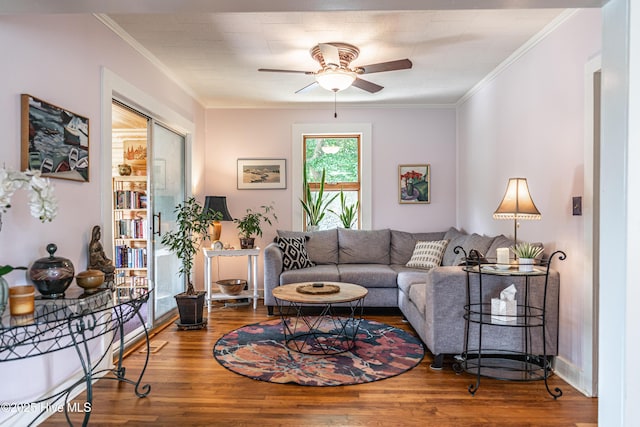 living area featuring ceiling fan, wood finished floors, and crown molding