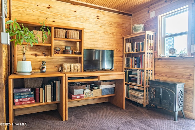 carpeted office space featuring wood walls and wood ceiling