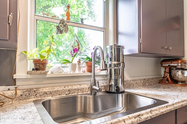 kitchen view of a sink and gray cabinetry