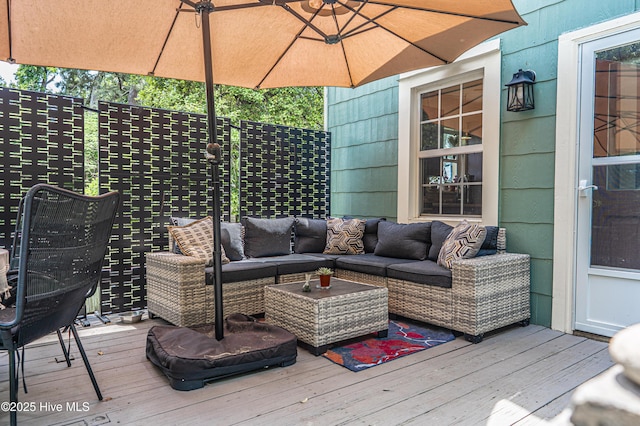 wooden terrace with an outdoor living space