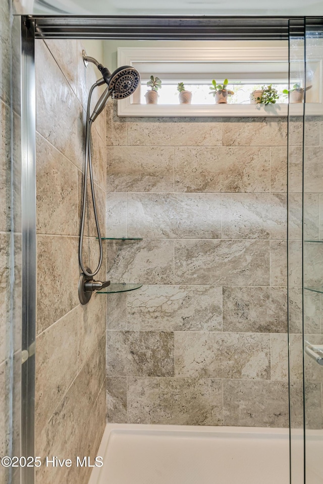 104 NE 63rd St, Oak Island, NC 28465 - bathroom featuring a tile shower and healthy amount of natural light