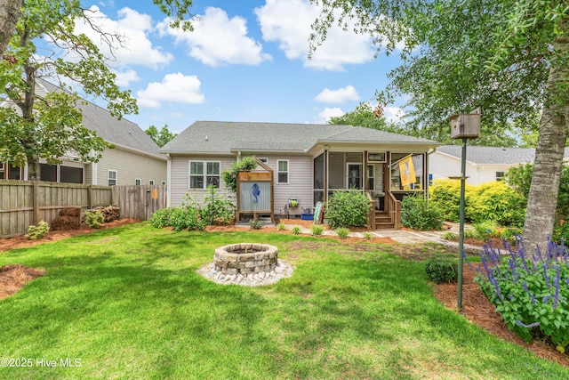 104 NE 63rd St, Oak Island, NC 28465 - back of property featuring an outdoor fire pit, a sunroom, and a shingled roof
