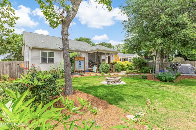104 NE 63rd St, Oak Island, NC 28465 - view of front of house featuring an outdoor fire pit, a sunroom, roof with shingles, and a wooden deck
