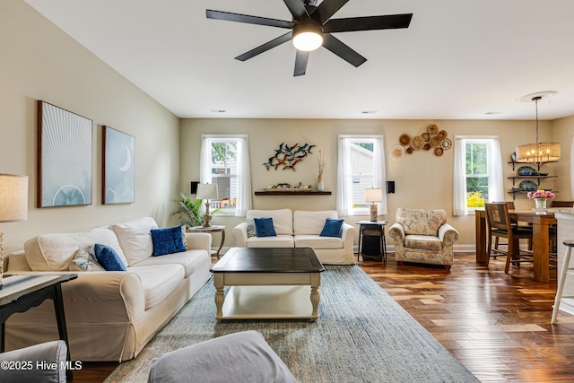 104 NE 63rd St, Oak Island, NC 28465 - living room featuring dark wood finished floors, ceiling fan, and a chandelier