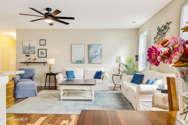 104 NE 63rd St, Oak Island, NC 28465 - living area featuring a ceiling fan, wood finished floors, and baseboards