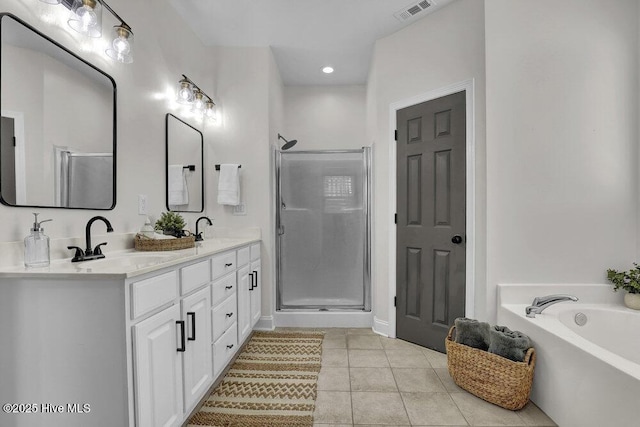 127 Azalea Dr, Hampstead, NC 28443 - bathroom featuring double vanity, tile patterned floors, a shower stall, a garden tub, and recessed lighting